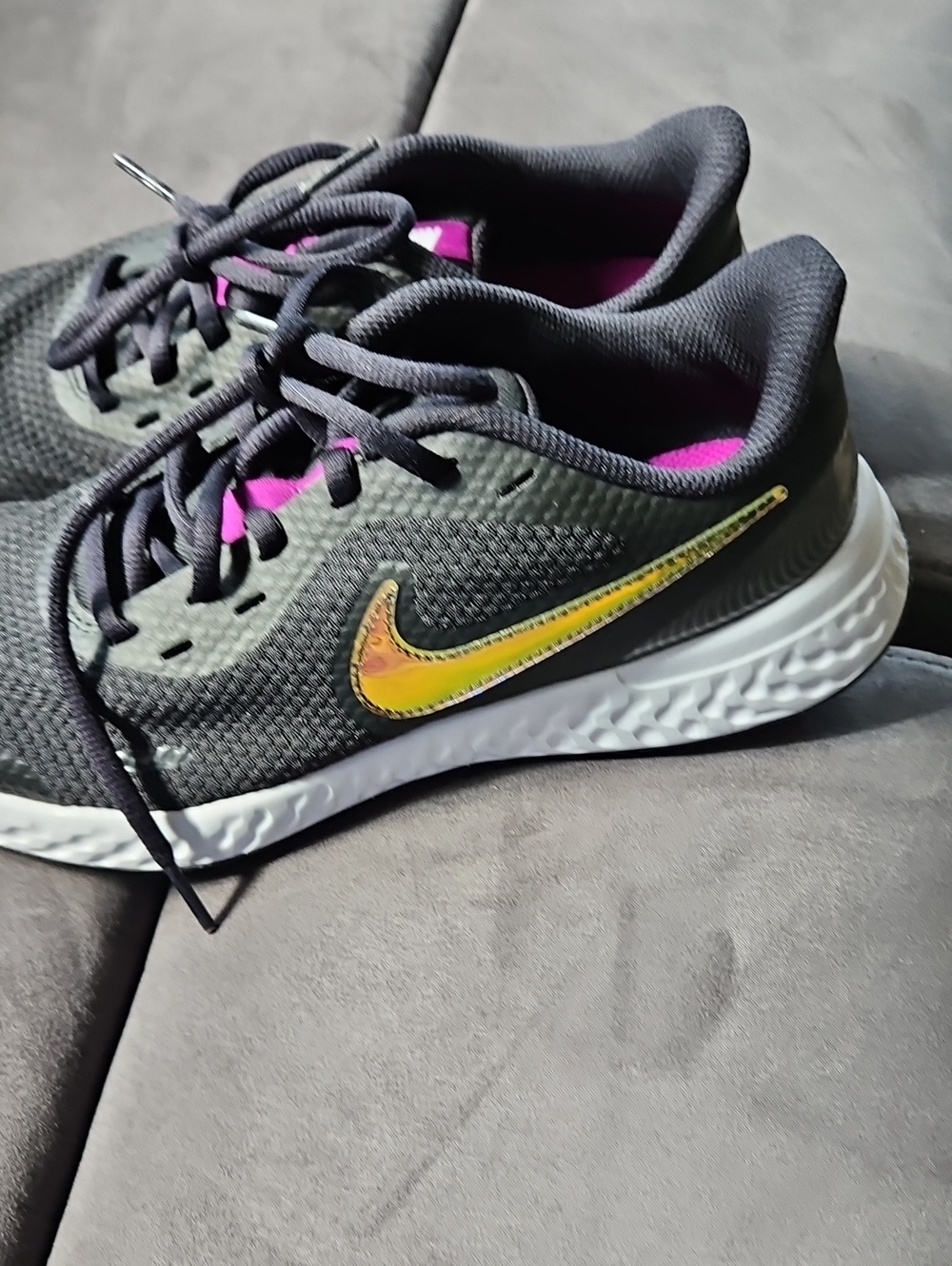 Nike Kid's Black Running Shoes with Iridescent Yellow-Gold Swoosh